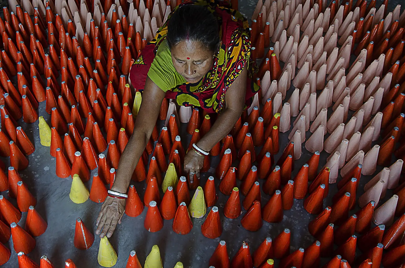 A Sivakasi worker arranging rows of handmade fireworks